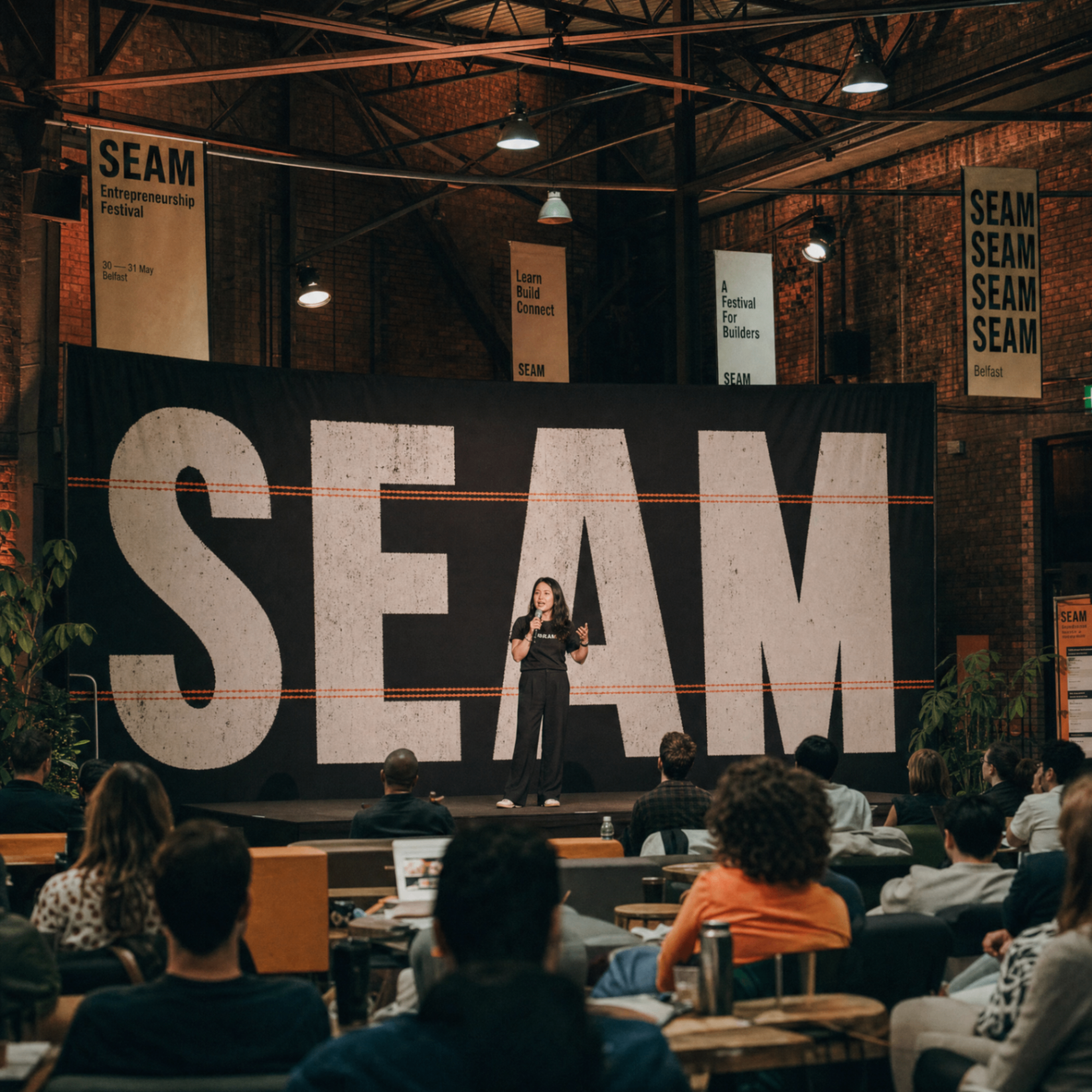Founder on the Main Seam stage with the SEAM backdrop